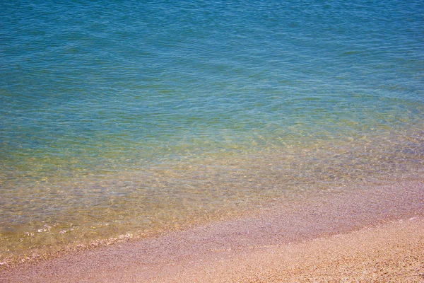 Shore beach water sea wave sand shells, background texture — Stock Photo, Image