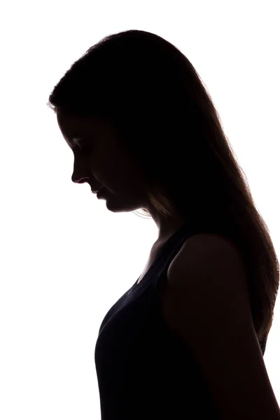 Young woman look down with flowing hair - vertical silhouette — Stock Photo, Image