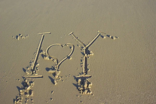 Lettering i love you on sand sunrise background sea, beach dawn wave — Stock Photo, Image