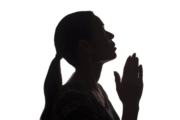 Young woman looking up with hope and request - silhouette — Stock Photo, Image