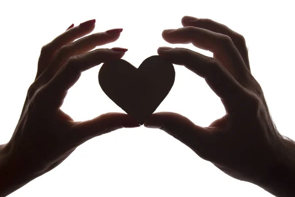 Symbol heart and love in female and male hands - silhouette Stock Picture