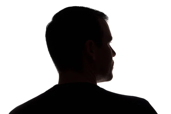 Portret van een jonge man, back View-donker geïsoleerd silhouet — Stockfoto