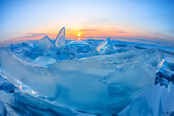 Transparente azul Toros Baikal gelo está brilhando através do pôr do sol crack — Fotografia de Stock