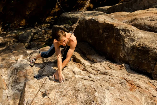 Extremkletterer besteigt einen Felsen an einem Seil mit der Top-Versicherung, Blick von oben — Stockfoto