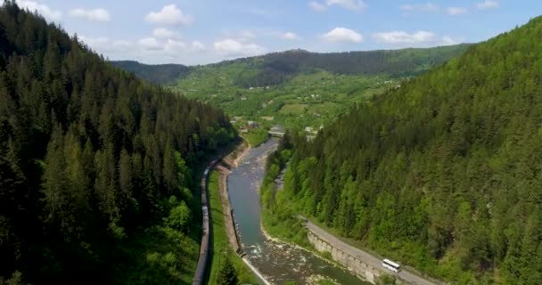 Beautiful aerial view to the road in the mountains. River between mountains. — Stock Video