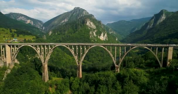 Vista aérea del puente del arco de Durdevica Tara en las montañas, uno de los puentes automovilísticos más altos de Europa . — Vídeo de stock