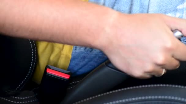 Closeup of man fastening seat belt in car. — Stock Video