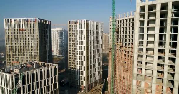 Aerial view of landscape in the city with under construction buildings and industrial cranes. Construction site. — Stock Video