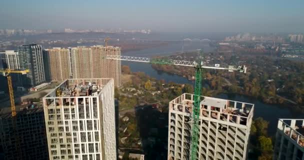 Вид с воздуха на ландшафт города со строящимися зданиями и промышленными кранами. Строительная площадка . — стоковое видео