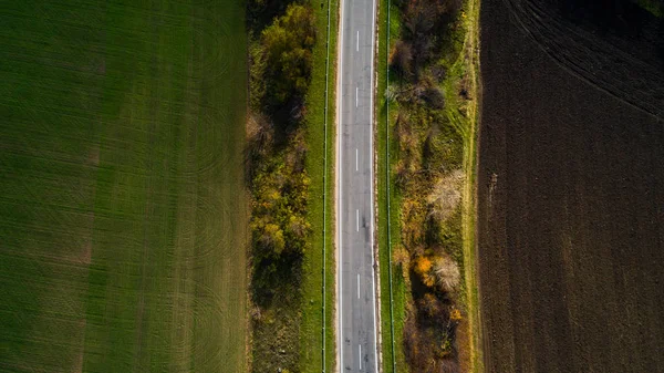 Vue aérienne de la route en automne. Paysage incroyable avec route rurale près du champ de blé . — Photo