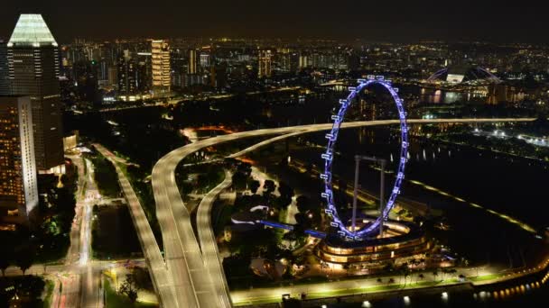 Singapore City Night Timelapse with Flyer Ferris Wheel With Traffic on Highway Buildings Towers and Sea Boats — Stock Video