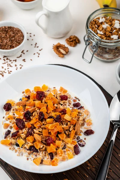 En hälsosam frukost. Granola müsli med mjölk, torkade aprikoser, tranbär, mandel och linfrön. Ren mat, kost, avgiftning, vegetarisk mat. — Stockfoto