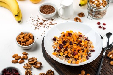 Sağlıklı kahvaltı. Sütlü müsli, kurutulmuş kayısı, kızılcık, badem ve keten tohumu. Temiz yemek, diyet, detoks, vejetaryen yiyecekler.