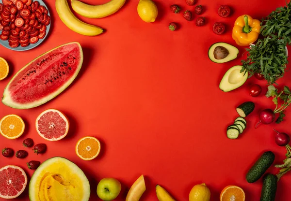 Healthy food menu from fruits and vegetables on the red background. Top view with copy space