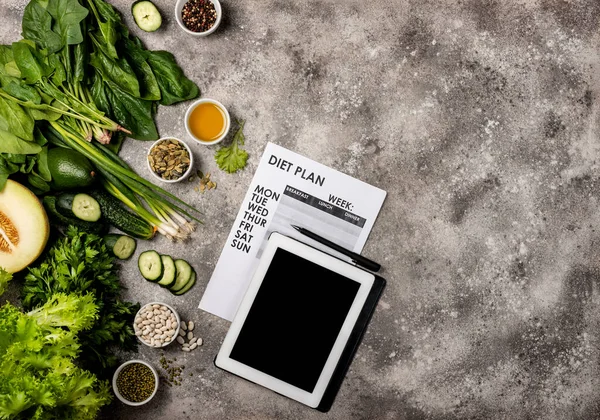 Diet plan concept. Healthy food set Tablet computer with blank screen and weight loss program. Top view.