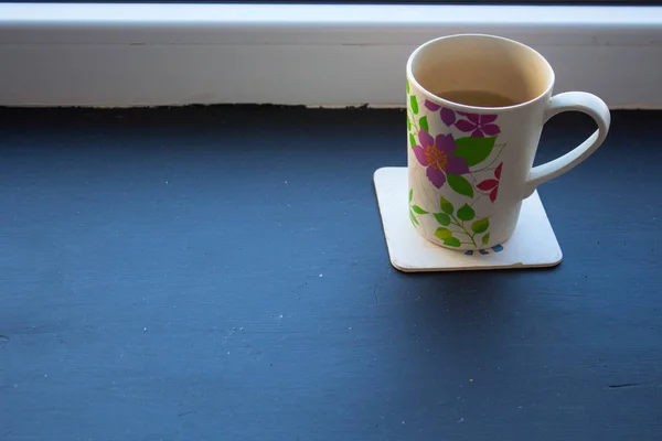 cup with tea near the window