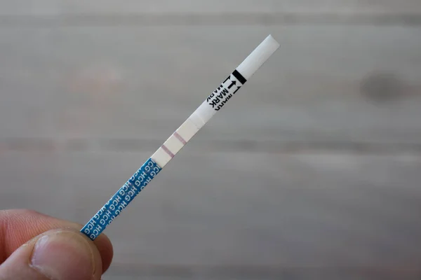 positive pregnancy test in the male hand