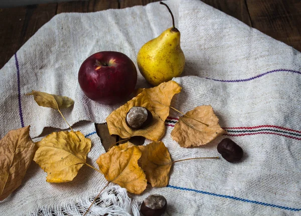 ripe apple and pear and yellow leaves and chestnut
