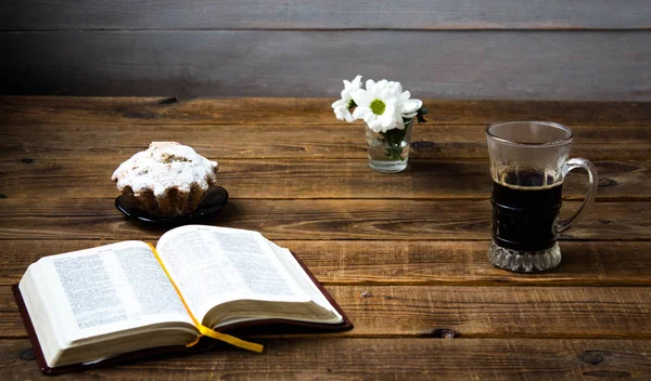 A coffee cupcake flowers and a book on a wooden background — Stock Photo, Image