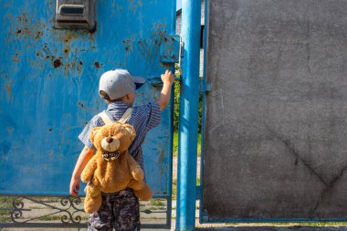 bir sırt çantası ile bahçesinde küçük bir çocuk