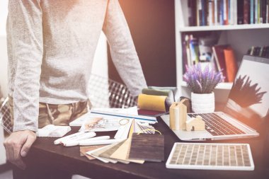 iş arkadaşları iç tasarımcılar veri yeni modern bilgisayar dizüstü bilgisayar ile tartışıyor. Mimarlar el malzeme örnek ile modern ev çizim üstten görünüm .