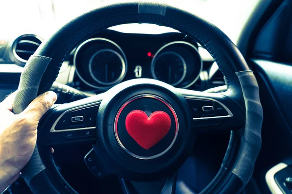 Steering wheel with heart red object.Love car concept idea.interior console car.