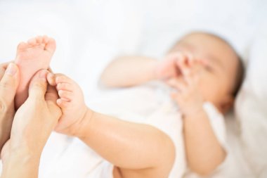 Odada Asyalı bebek mutlu. Asya bebek kız yatarken aşağı üzerinde yatak .