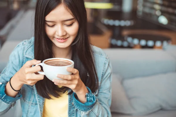Attractive Asian woman drinking coffee.cheerful girl drinking co