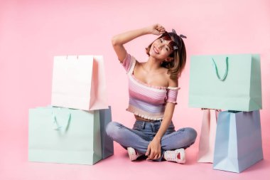 Asya güzel genç kadın pembe pastel arka plan üzerinde yürüyüş. S
