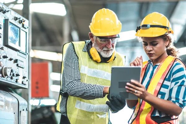 Industrial Engineers in Hard Hats.Work at the Heavy Industry Manufacturing Factory.industrial worker indoors in factory.aged man working in an industrial factory.