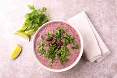 Geleneksel ev yapımı Meksikalı kırmızı fasulye püresi çorba, limon, maydanoz ve kırmızı biber biber. Sıcak ve baharatlı vejetaryen yemek.