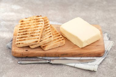 Tost ve tereyağı bıçağı ve peçete ile gri kayrak arka plan günü kahvaltıda. Yatay görünüm