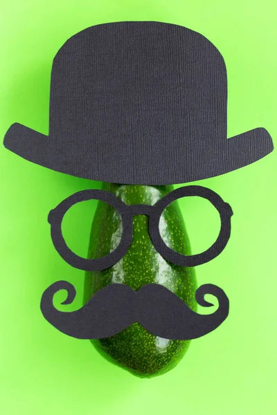 Funny male silhouette pattern on the green background. Cute party face with avocado. movember. Prostate Cancer and men's health awareness.