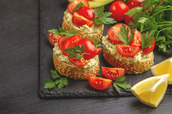 Bruschetta Med Hackad Körsbärstomater Mixa Avokado Och Färsk Persilja Svart — Stockfoto