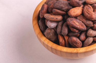 Aromatik ham kakao çekirdekleri dolu gri mermer zemin üzerine kase. Yatay görünüm. Kopya alanı