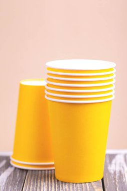 Parlak ve renkli kağıt bardak ahşap masa üzerinde geri dönüşüm. Yatay görünüm. Uzay kopyalayın. Parti ve geri dönüşüm kavramı