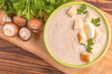 Lezzetli mantar çorbası malzemeler kil kase ezilmiş. Sağlıklı gıda kavramı. Rustik ahşap arka plan. Üstten görünüm. Kopya alanı