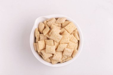 Işık kil kase mısır yastıkları arka plan beyaz. Sağlıklı tahıllar kahvaltı. Kopya alanı