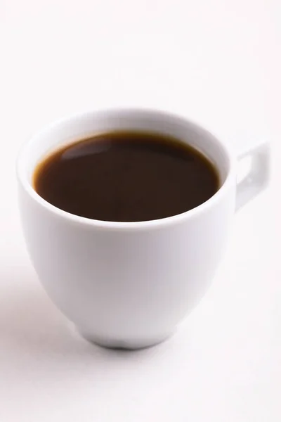 Cup of black strong coffee for breakfast on light marble background. Copy space. Horizontal view