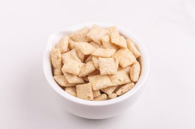 Işık kil kase mısır yastıkları arka plan beyaz. Sağlıklı tahıllar kahvaltı. Kopya alanı