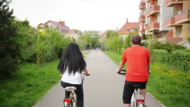 Portrait of Attractive Beautiful Couple in Casual Outfits Jeans Overall Riding Retro Bikes Enjoying Cycling Together. — Stock Video