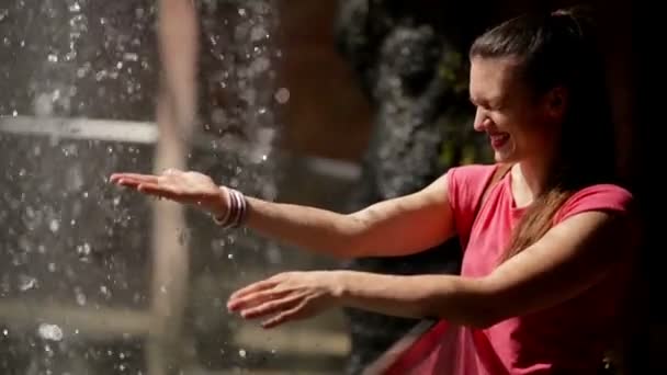 A Woman Enjoying Water Falling on Her Hands. She is in Good Mood. — Stock Video