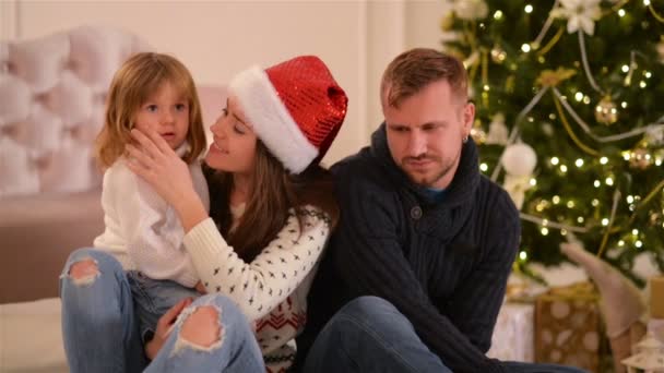 Mom, Dad And Little Baby Daughter . Loving Family Merry Christmas and Happy New Year. Cheerful Pretty People. Parents And Child Having Fun Near Christmas Tree Indoors. — Stock Video