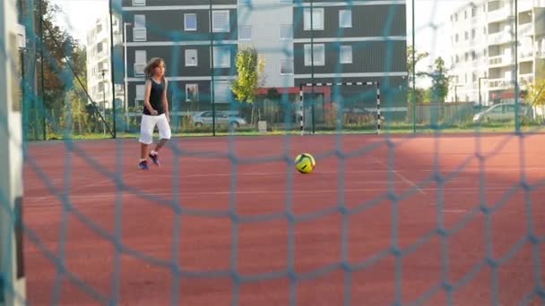 A Little Boy Scores A Goal Kicks Ball. He Has A Lot of Fun Playing Soccer Outdoors. — Stock Video