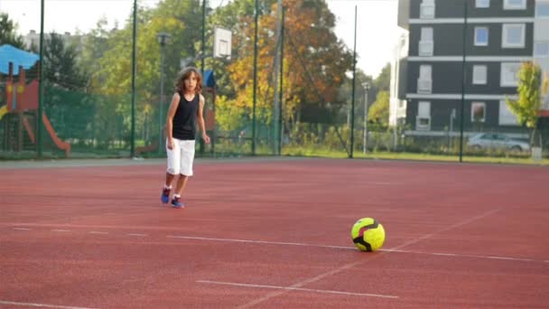 Ein kleiner Junge schießt ein Tor im Penaltyschießen. Zeitlupe. Draußen. Sport als Quelle des Gesundheitslebens. — Stockvideo