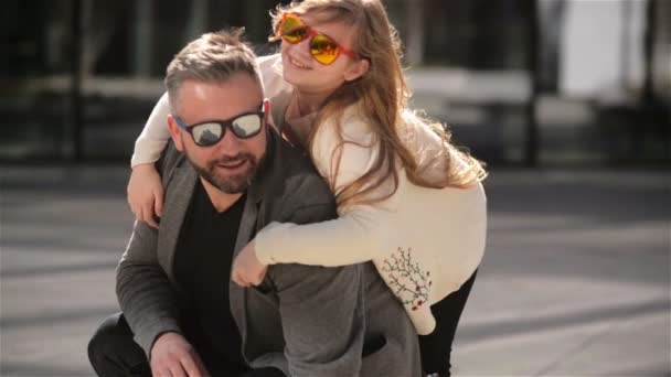 Portrait of Young Father Carrying His Daughter On His Back. Family Having a Lot of Fun Spending Fathers Day Together. — Stock Video