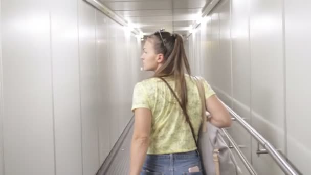 Vue arrière de la jeune femme marchant dans l'allée en avion — Video