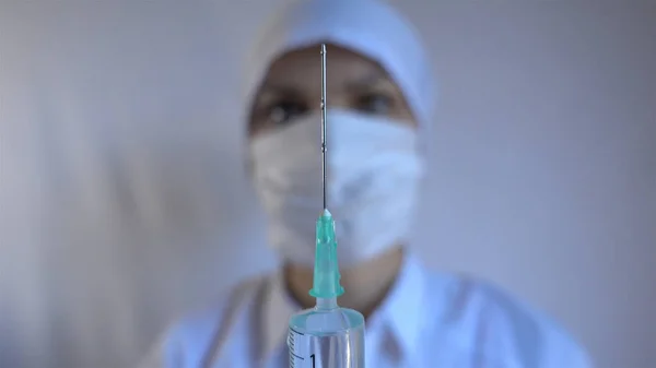 Close-up shot of syringe during injection, drug addiction problem, aids epidemic, vaccination. Medicine liquid delivering to patient body, hospital treatment, health care system, clinic therapy — Stock Photo, Image