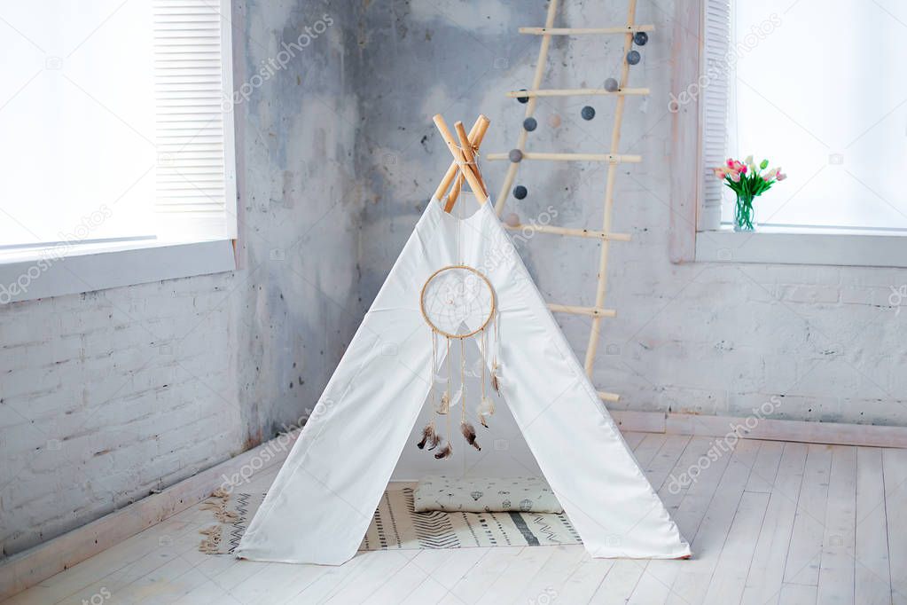 Children's tent with cushions at the window in the studio, children's room, dream catcher