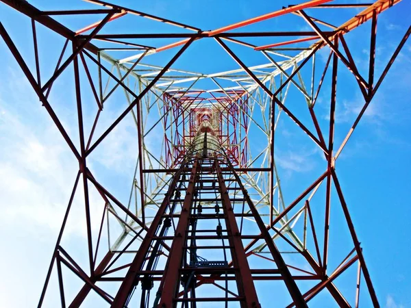 View from the bottom of mobile telephone network with blue sky background